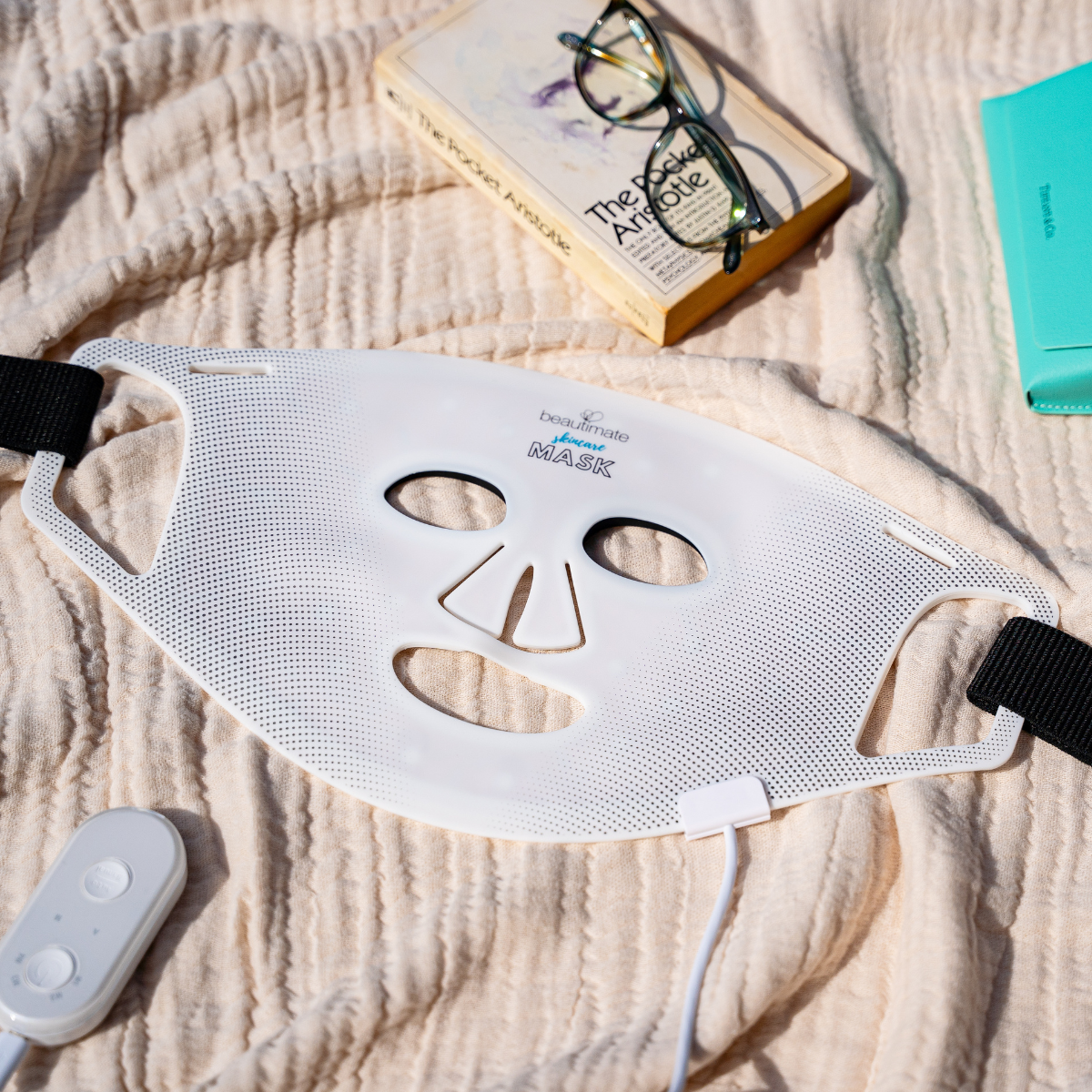  LED Light Therapy Mask with a book and glasses