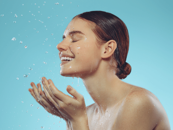 woman washing her face before microneedling 